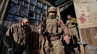A Ukrainian serviceman leaves a command post to start his shift at a frontline position outside Popasna, in the Luhansk region, eastern Ukraine, Feb. 20, 2022.