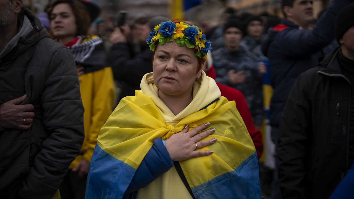 Demonstrators sing the national anthem during a protest in Odessa, Ukraine, Sunday, Feb. 20, 2022, to mark the eighth anniversary of the Maidan revolution. 