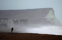 A person walks on Seaford Beach, as Storm Eunice hits Seaford and the south coast of England, Friday, Feb. 18, 2022.
