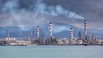 Smoke over an oil refinery.