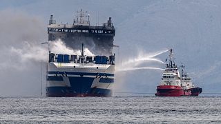 Smoke rises from the Italian-flagged Euroferry Olympia, which is on fire for third day, in the Ionian Sea near the Greek island of Corfu, on Sunday, Feb. 20, 2022.