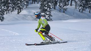 Indian skier Arif Mohammad Khan skies down a slope during a training session at a ski resort in Gulmarg