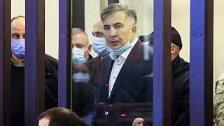 Former Georgian President Mikheil Saakashvili gestures speaking from a defendant's dock during a court hearing in Tbilisi, Georgia, Dec. 2, 2021.