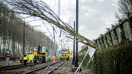 Workers carry out repair work on an overhead line and a railway in Maarssen on February 19, 2022, after Storm Eunice hit northern Europe.