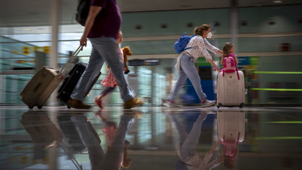 Tourists arrive at Barcelona airport