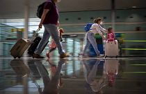 Tourists arrive at Barcelona airport