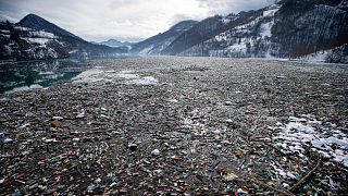 Plastic bottles and other rubbish floats in the Potpecko lake near Priboj, in southwest Serbia.