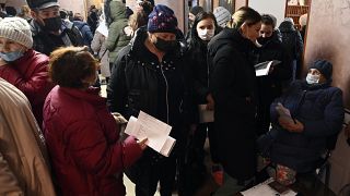 People from Donetsk gather to fill in documents after evacuating in the Rostov-on-Don region, near the border with Ukraine, Russia, Sunday, Feb. 20, 2022