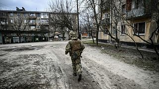 A Ukraine army soldier walks in the town of Schastia, near the eastern Ukraine city of Luhansk, on February 22, 2022