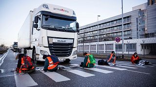 Climate activists stuck their hands on a crosswalk to block an access road to the cargo area from Munich Airport in Munich, Germany.