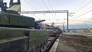 Feb. 15, 2022, Russian armored vehicles are loaded onto railway platforms after the end of military drills in South Russia.