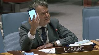 kraine's Ambassador to the United Nations Sergiy Kyslytsya, holds up a phone as he speaks an emergency meeting of the U.N. Security Council Wednesday, Feb. 23, 2022, at the UN