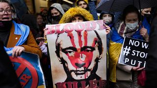 Pro-Ukraine people shout slogans during a small protest outside the Russian consulate in Istanbul, Turkey, Thursday, Feb. 24, 2022.