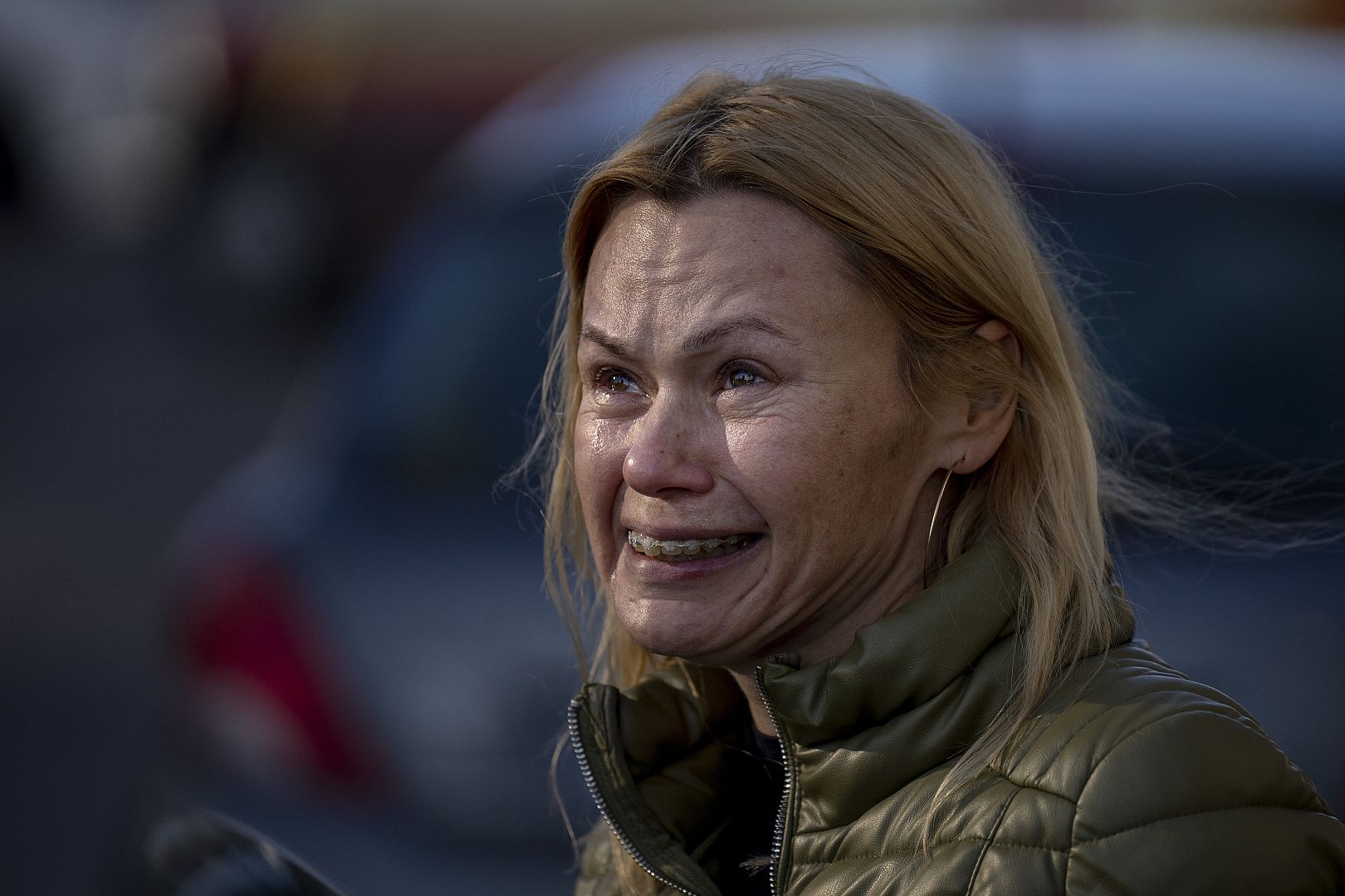 A woman cries looking at her apartment building damaged following a rocket attack, in Kyiv, Ukraine. February 26, 2022