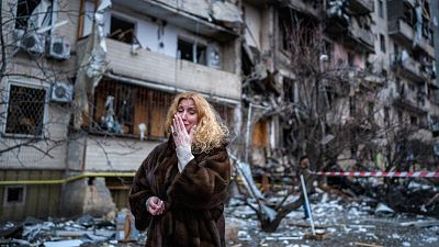 Kyiv resident Natalia Sevriukova reacts next to her house following a rocket attack on Kyiv, Ukraine. February 25, 2022