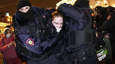 Police officers detain a demonstrator in St. Petersburg