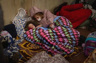 Families in Kyiv are sheltering in metro stations as Russian forces encircle the city