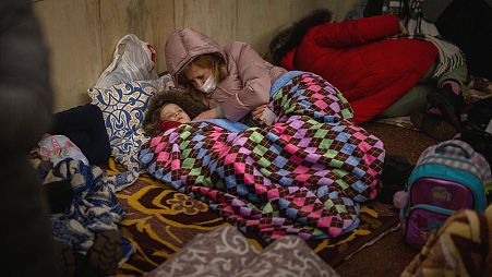 Families in Kyiv are sheltering in metro stations as Russian forces encircle the city