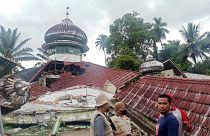 People inspect a damaged mosque in Pasaman, West Sumatra.
