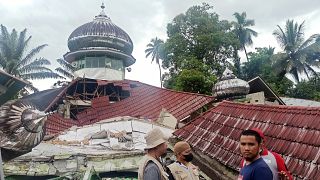People inspect a damaged mosque in Pasaman, West Sumatra.