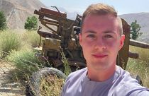 Miles Routledge takes a selfie with military equipment