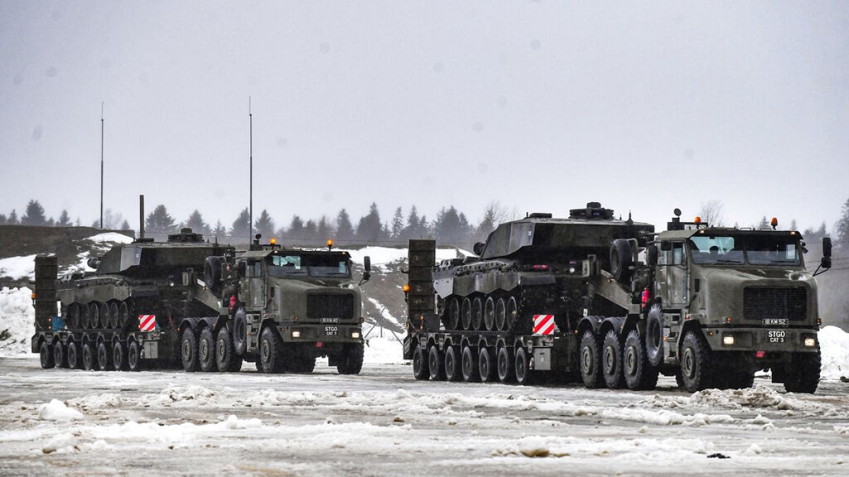 Military trucks carry tanks as a part of additional British troops and military equipment upon their arrival at Estonia