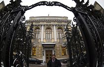 A man walks in front of Russia's Central Bank building in Moscow, Russia, Friday, Jan. 30, 2015. 