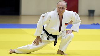 In this pool photo taken on Thursday, Feb. 14, 2019, Russian President Vladimir Putin, right, attends a training session with the Russian national judo team