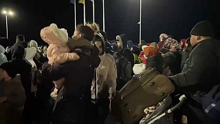 Ukrainian refugees disembark the ferry across the Danube at Isaccea, Romania