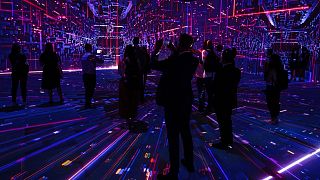 Visitors watch a projection at the TelcoDR booth during the Mobile World Congress 2021 in Barcelona, Spain, Tuesday, June, 29, 2021.