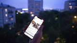 File - A user holds a smartphone with an opened Facebook page in Moscow, Russia, June 10, 2021.