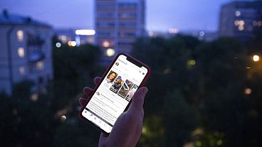 File - A user holds a smartphone with an opened Facebook page in Moscow, Russia, June 10, 2021. 