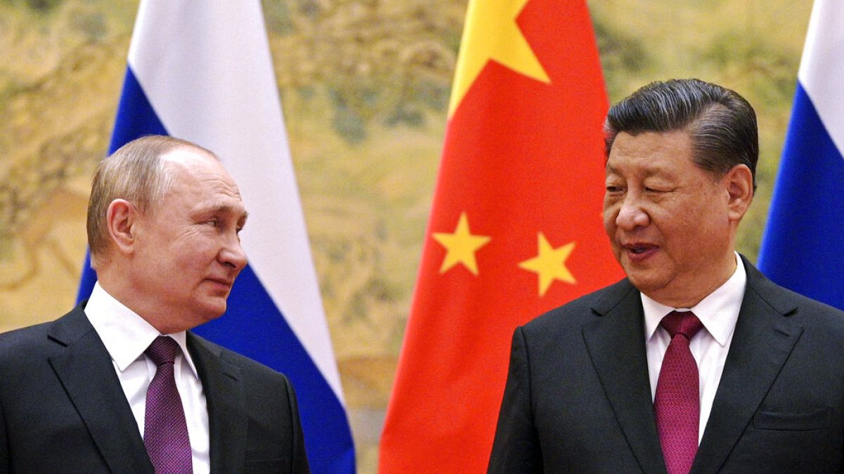  Chinese President Xi Jinping, right, and Russian President Vladimir Putin talk to each other during their meeting in Beijing