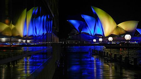 The sails of the Opera House are illuminated with the colors of Ukraine's national flag on Feb 28, 2022, in solidarity with the country's people and government