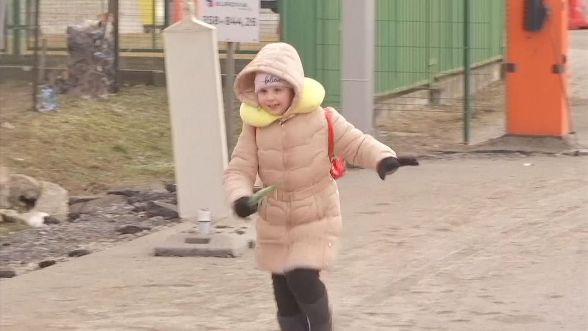 Little girl running as she recognizes loved one on Polish side of border