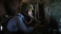 President Volodymyr Zelenskyy looks at a front-line position from a shelter as he visits eastern Ukraine