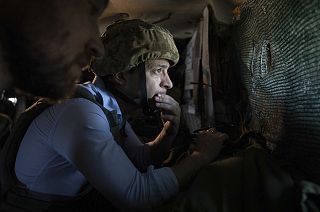 President Volodymyr Zelenskyy looks at a front-line position from a shelter as he visits eastern Ukraine - 2019