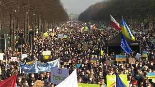 Demonstrators fill the street between the Brandenburg gate and the Victory column in Berlin
