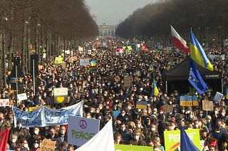 Demonstrators fill the street between the Brandenburg gate and the Victory column in Berlin