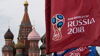 A flag with the logo of the World Cup 2018 on display with the St. Basil's Cathedral in Moscow