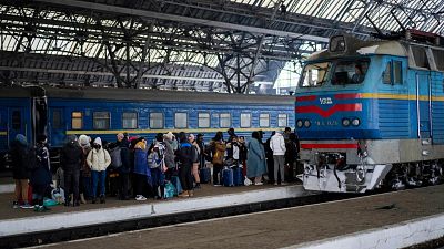 People trying to flee Ukraine stand on a platform as they wait for trains inside Lviv railway station. People trying to flee Ukraine stand on a platform as they wait for trains inside Lviv railway station.