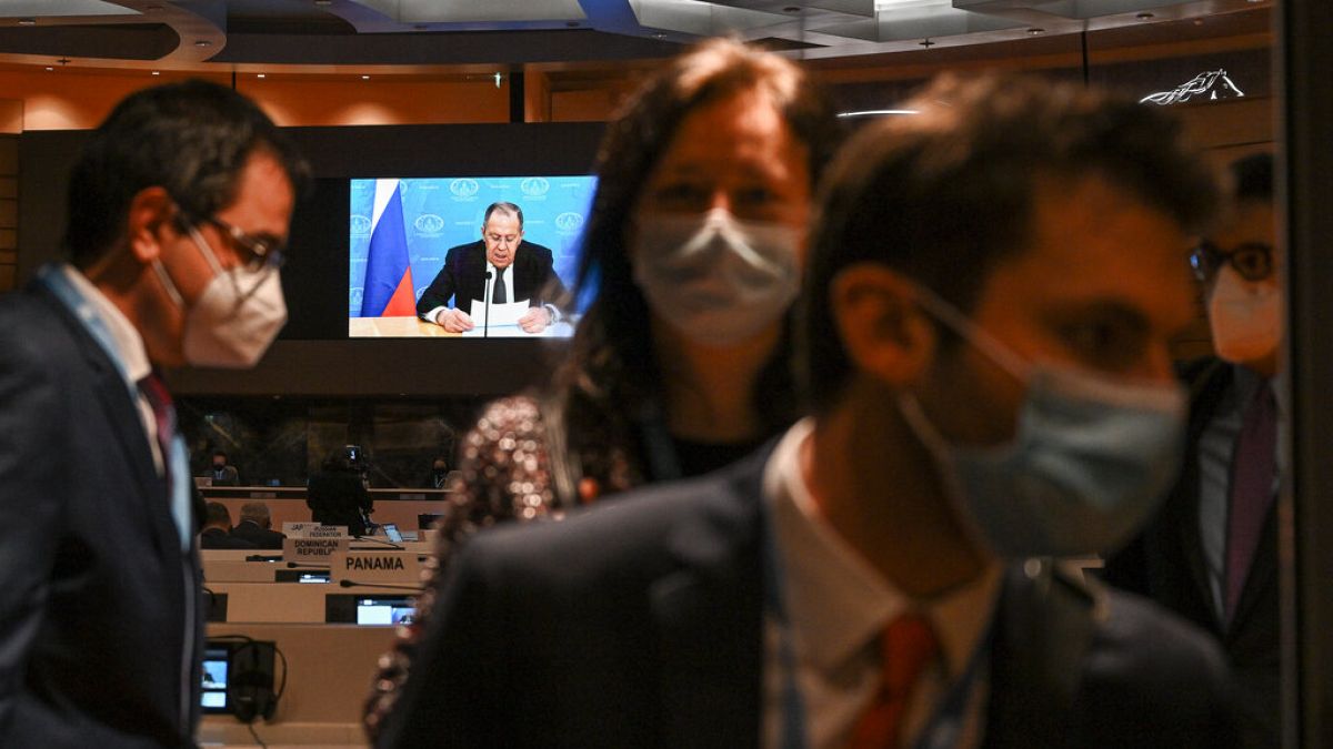 Ambassadors and diplomats leave the room while Russia's foreign minister Sergei Lavrov addresses with a pre-recorded video message the Conference on Disarmament