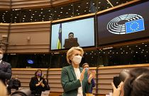 European Commission President Ursula von der Leyen applauds after an address by Ukraine's President Volodymyr Zelenskyy, via video link, during a session on Ukraine