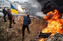 Volunteers prepare Molotov cocktails in one of the local parks in Uzhgorod, western Ukraine. February 28, 2022.