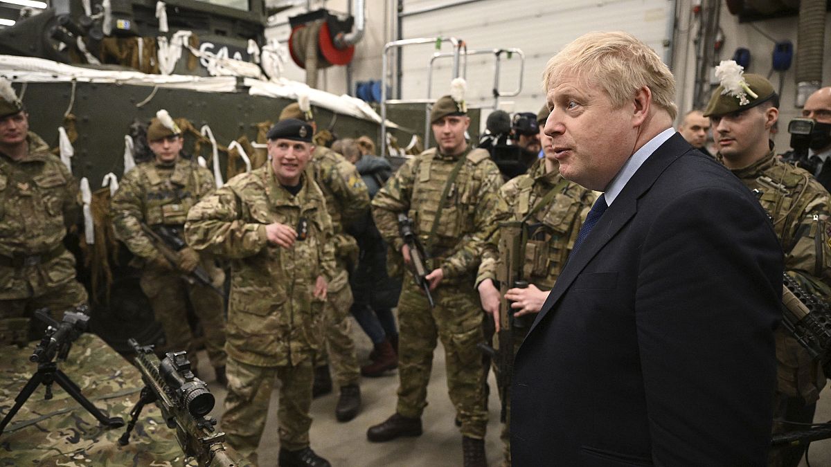 British Prime Minister Boris Johnson meets NATO troops after a joint press conference at an airbase in Tallinn, Tuesday, March 1, 2022. 