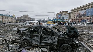 A damaged car sits at the central square following shelling of the City Hall building in Kharkiv, Ukraine, March 1, 2022.