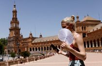 A woman fans herself during the first heatwave of the year in Seville, June 11.
