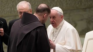 Friar Marek Viktor Gongalo, from Ukraine, is greeted by Pope Francis during the weekly general audience at the Vatican, March 2, 2022.