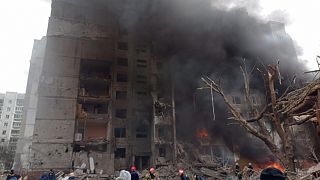 Firefighters work to extinguish a fire at a damaged city center after Russian air raid in Chernigiv, Ukraine, March 3, 2022. 