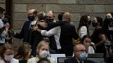 Delegates hug at the Fifth session of the United Nations Environment Assembly (UNEA 5) after negotiating a global plastic treaty.
